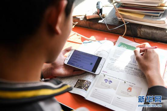  3月10日，內(nèi)蒙古準(zhǔn)格爾旗龍口鎮(zhèn)紅樹(shù)梁村的初一學(xué)生劉進(jìn)才在家中上網(wǎng)課。&nbsp;新華社記者 劉磊 攝